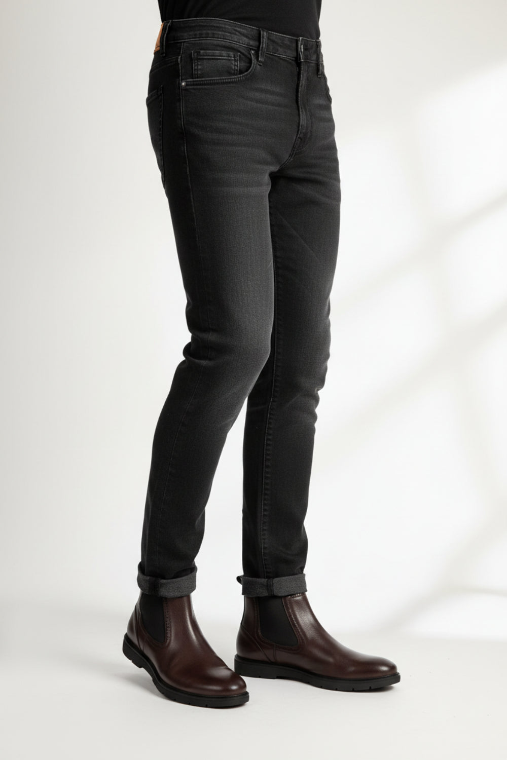 a man wearing a brown chelsea boots 
