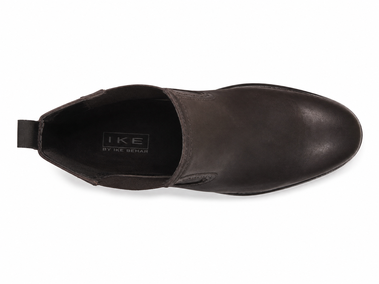 A dark brown leather slip-on shoe shown from a top-down view on a white background, with the brand name 'IKE BY THE SEAM' visible on the inner sole.