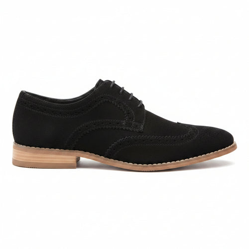A single black suede wingtip oxford shoe with a tan and black stacked heel, shown from a three-quarters angle on a white background.