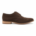A dark brown suede wingtip oxford shoe with brogue detailing, laces, and a stacked leather sole, shown on a white background.