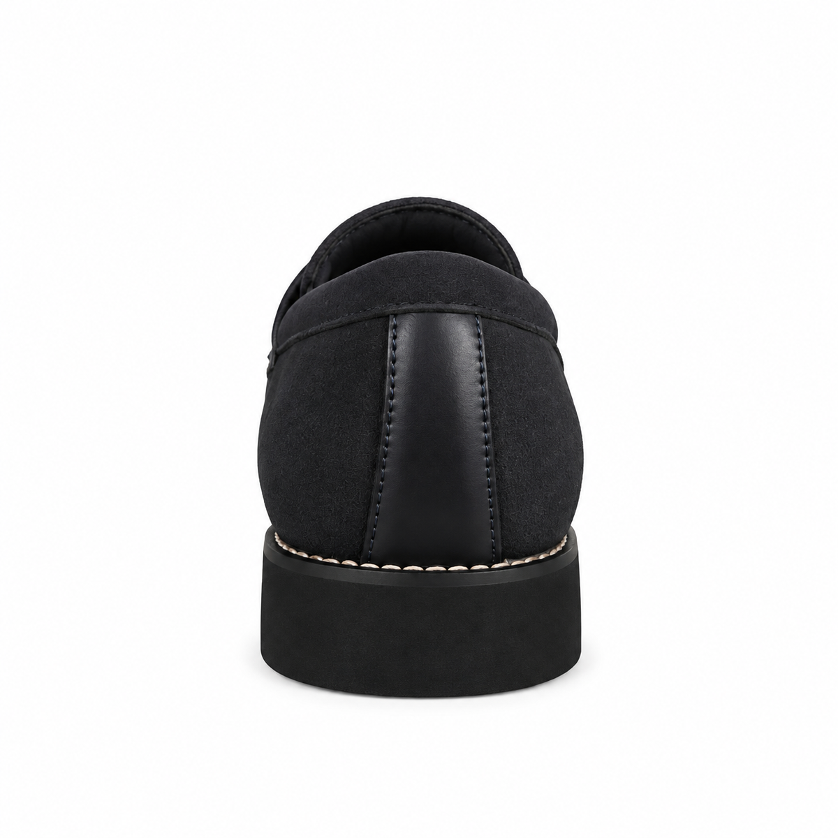 A black slip-on shoe shown from the back, featuring a mix of matte suede and smooth leather panels, a thick black sole, and light beige contrast stitching.