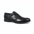A single black leather double strap loafer shoe with a cap toe, shown from a side profile on a light gray reflective surface.