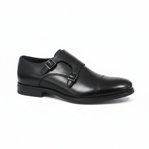 A single black leather double strap loafer shoe with a cap toe, shown from a side profile on a light gray reflective surface.