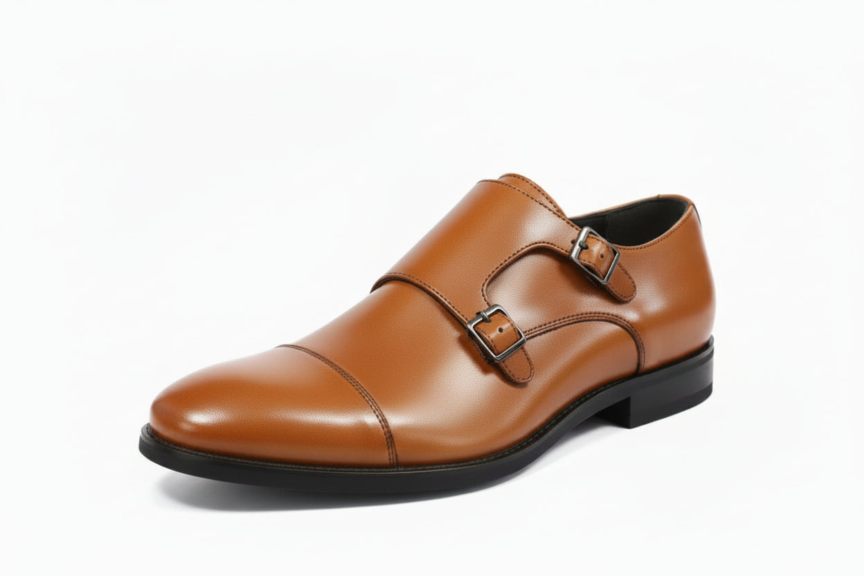 tan faux  leather double monk strap dress shoe with a cap toe and black sole, shown from a three-quarters angle on a white background.