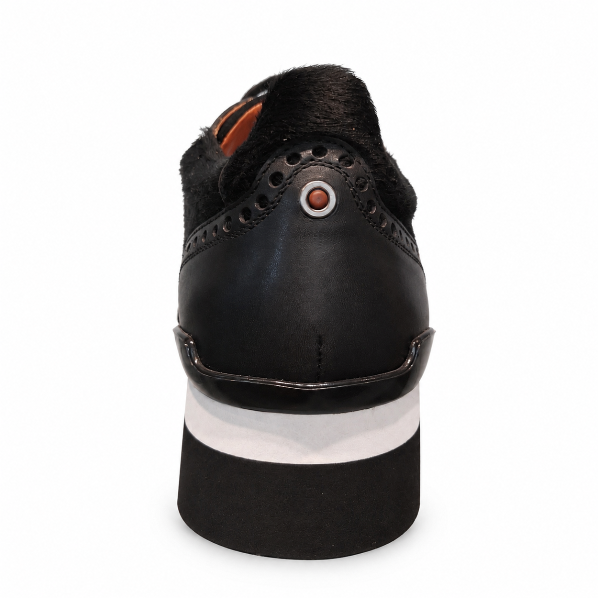 A black leather sneaker with a black faux-fur collar, a chunky platform sole with a white stripe, and a silver circular eyelet, shown from a rear three-quarter view on a white background.