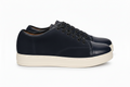 Black sneaker with white sole on a white background