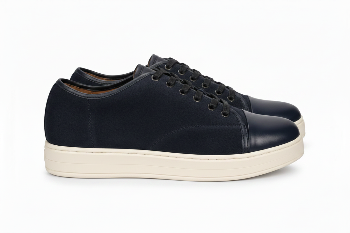 Black sneaker with white sole on a white background