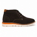 A single dark brown suede chukka boot with black laces, a tan leather heel tab, and a thick white sole featuring a vibrant orange midsole accent, shown from a side profile on a white background.