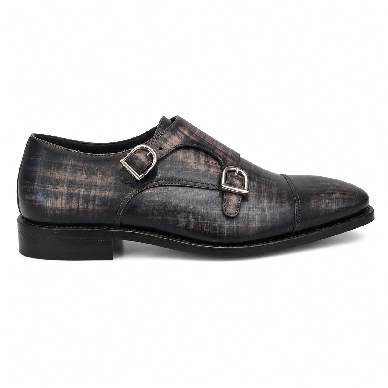 A single men's double strap monk shoe in distressed black leather with silver-tone buckle hardware, shown in a side profile on a white background.