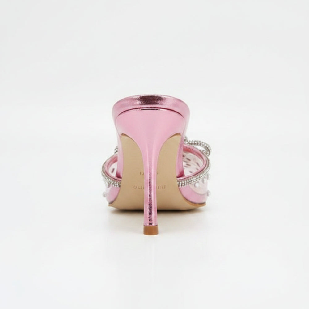 A pink pointed-toe mule high heel featuring a transparent mesh upper, silver rhinestone trim, a decorative crystal bow, and a metallic pink stiletto heel, shown against a plain white background.