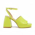 A single lime green platform sandal with a chunky block heel and ankle strap, shown from a side profile on a white background.
