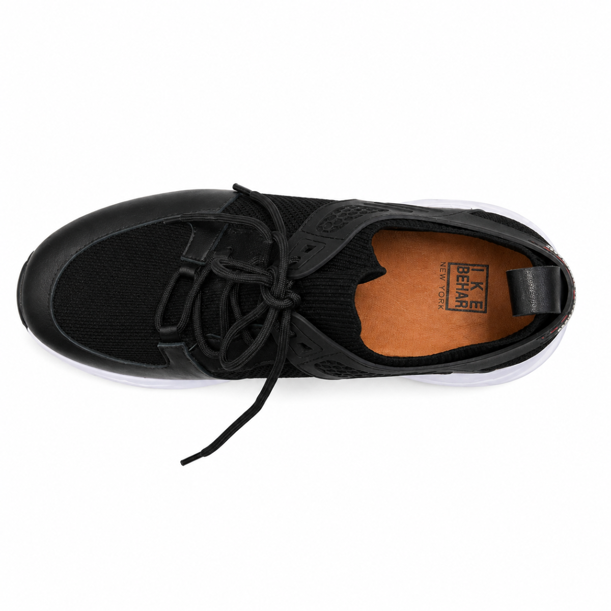 A black knit slip-on sneaker with a white sole, shown from a top-down view on a white background. The brand name 'K BEAR' is visible on the tan insole.