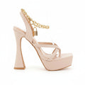 A single women's platform high-heel sandal in pale blush pink with clear plastic straps, a gold chain ankle strap, and a gold padlock detail, shown on a plain white background.