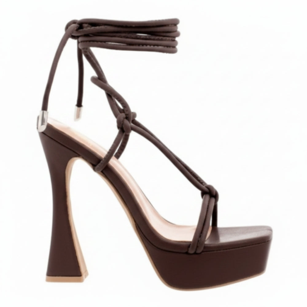 A dark brown platform high-heeled sandal with an ankle-strap design, featuring a chunky block heel and a light beige insole, shown against a plain white background.