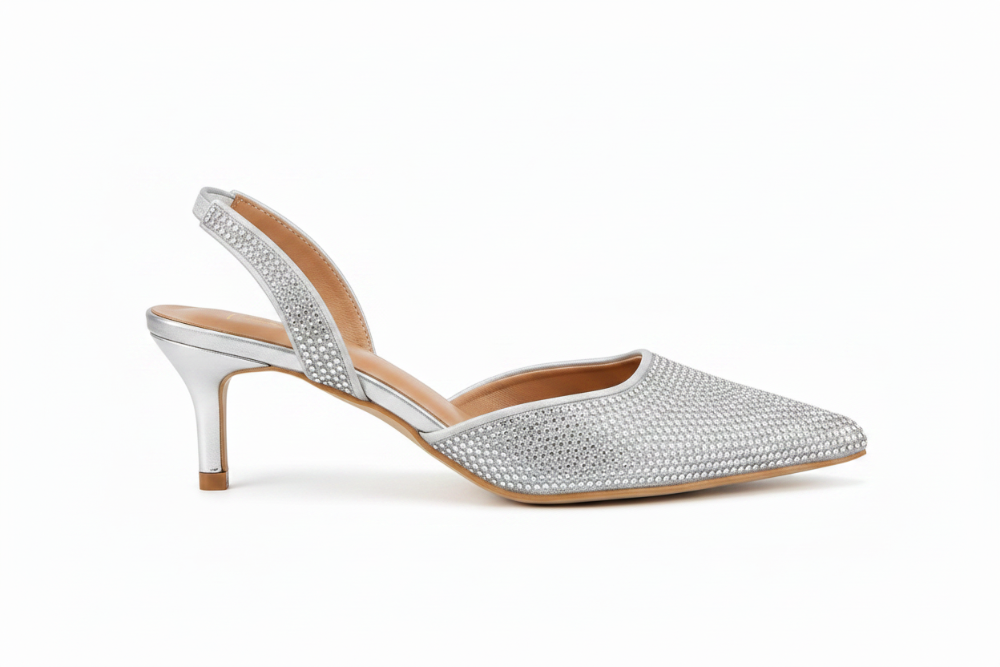 A single women's slingback kitten heel shoe covered in sparkling silver rhinestones, featuring a pointed toe and a low kitten heel, shown on a plain white background.