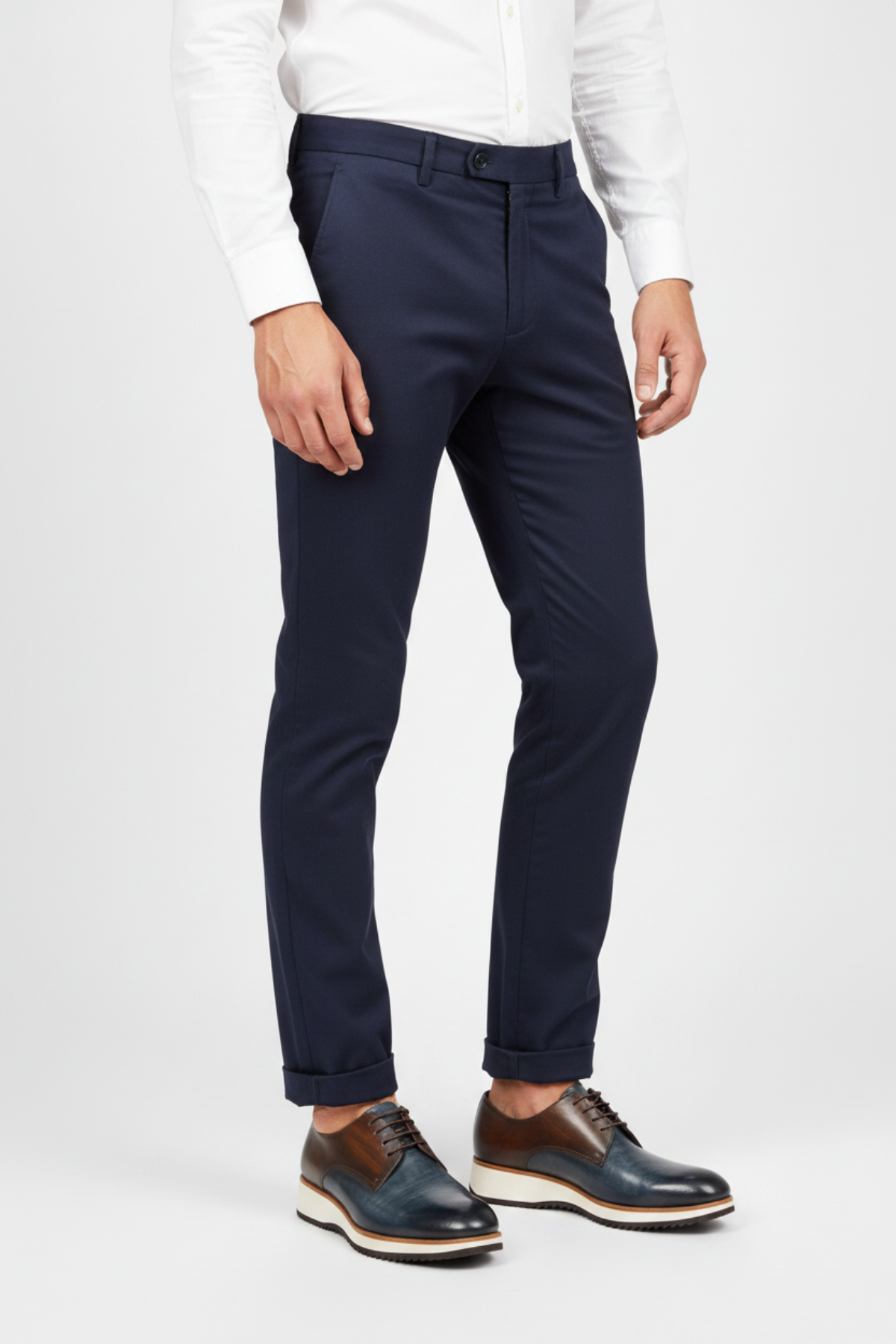A men's low-top lace-up dress shoe with a color-blocked design featuring dark brown leather on the upper, a dark blue-gray leather toe, and a thick cream-colored midsole with a black tread.