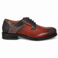 A men's three-tone leather lace-up dress shoe with a smooth reddish-brown vamp, dark brown side panels, and black textured heel and toe caps, shown in profile against a white background.
