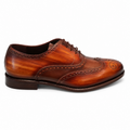 Side profile of Trezor men's hand-painted cognac patina full-grain leather wingtip brogue Oxford with perforated medallion toe, dark brown waxed laces, and stacked leather heel