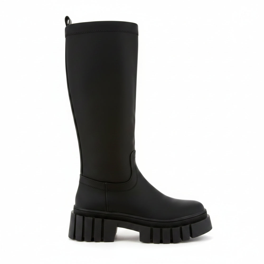 A single black knee-high boot with a chunky lug sole, shown from a side profile on a plain white background.