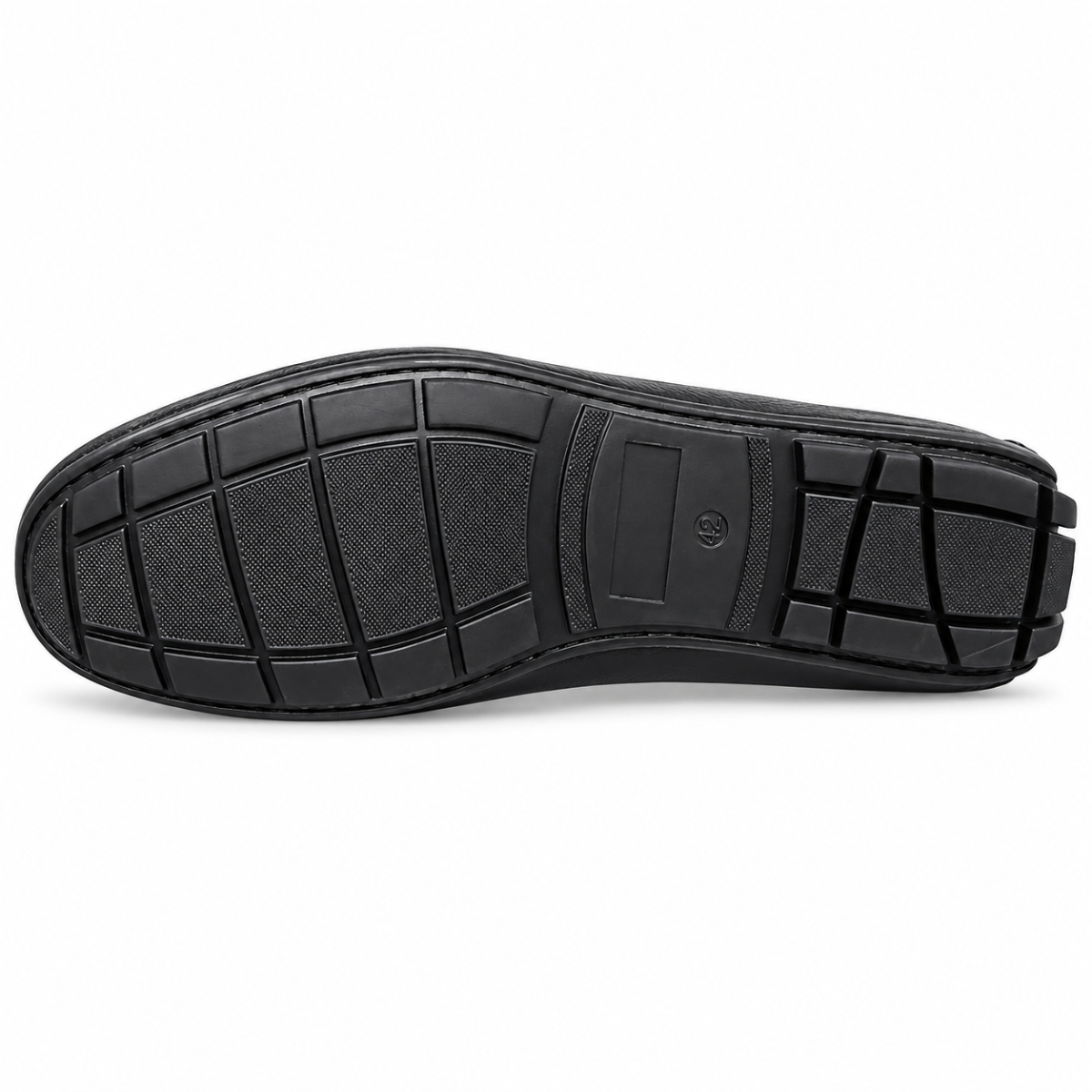 The black rubber outsole of a shoe, showing its tread pattern and textured grip blocks, photographed from a top-down view on a white background.
