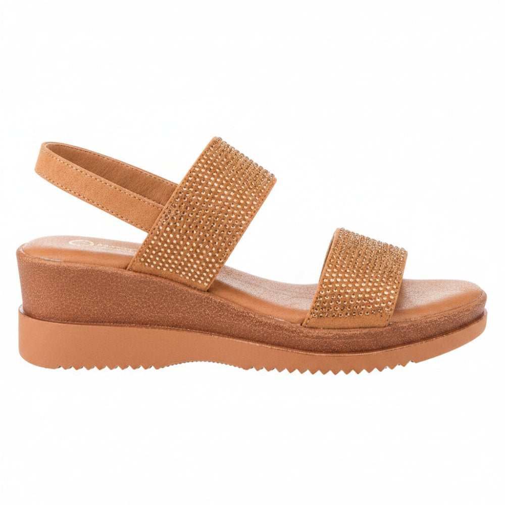 A tan wedge sandal with two embellished straps, shown in a side profile view against a plain white background.