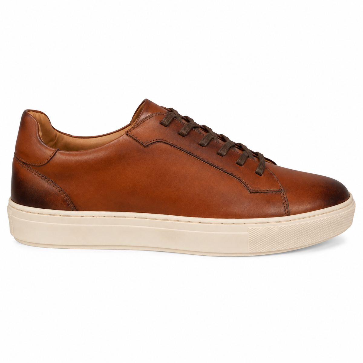 A classic low-top leather sneaker in a warm cognac brown, featuring dark brown laces and a thick, chunky off-white rubber sole, shown from a side profile on a white background.